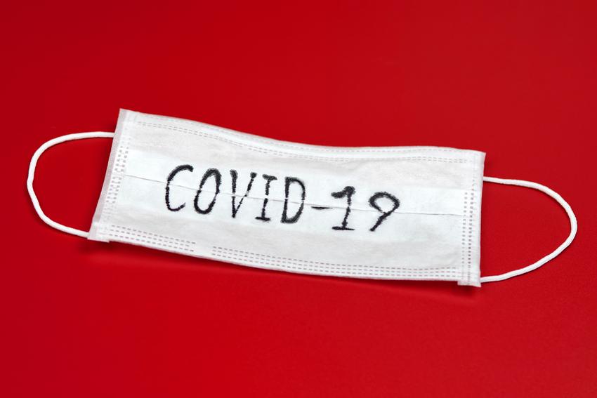 COVID-19 - Novel coronavirus - 2019-nCoV, WUHAN virus concept. Surgical mask protective mask with COVID-19 text. Chinese coronavirus outbreak. Red background. (COVID-19 - Novel coronavirus - 2019-nCoV, WUHAN virus concept. Surgical mask protective mas